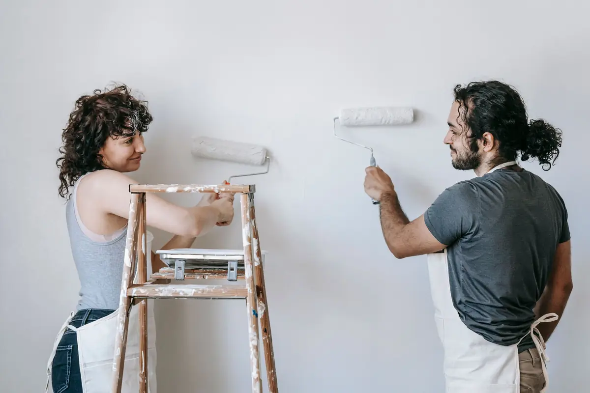 People painting a wall together — painting help in Green Bay